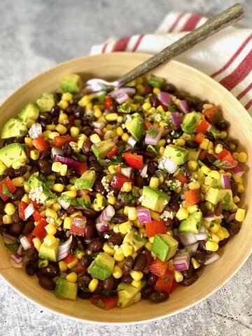 striped red napkin and bowl of black bean and avocado