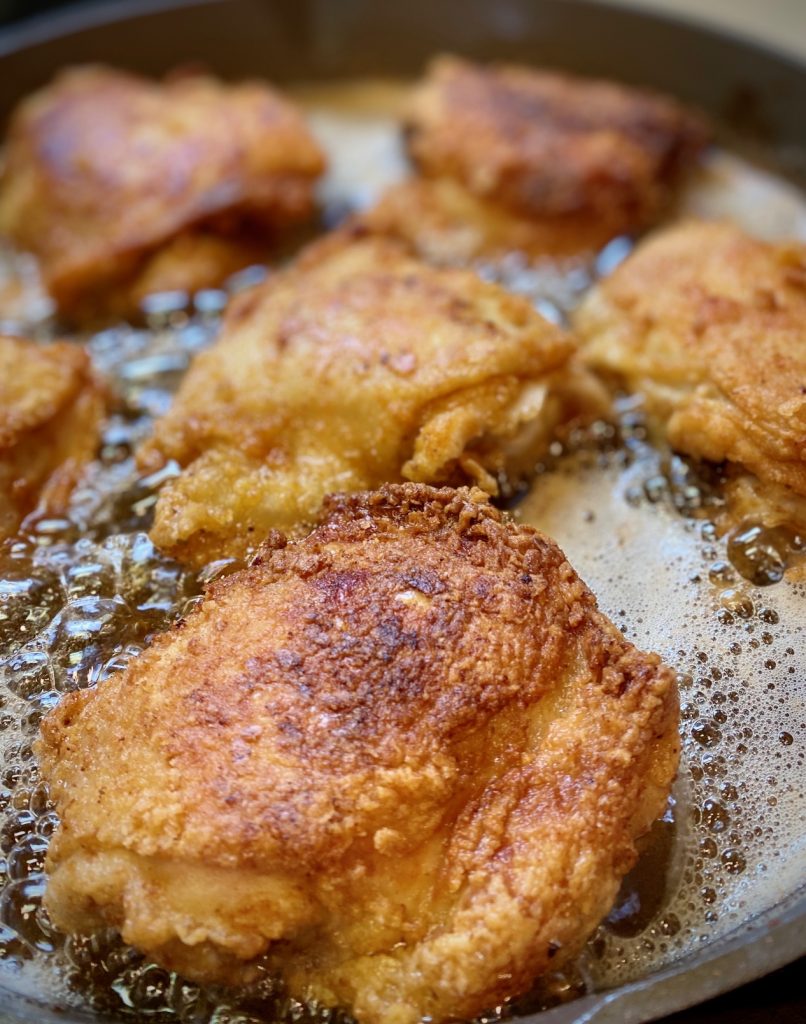 chicken frying in a pan