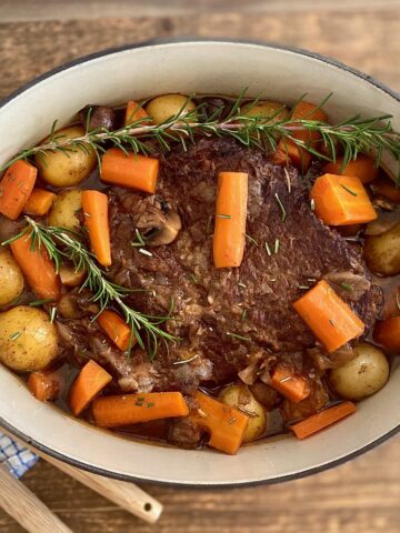 Pan of pot roast with spoons