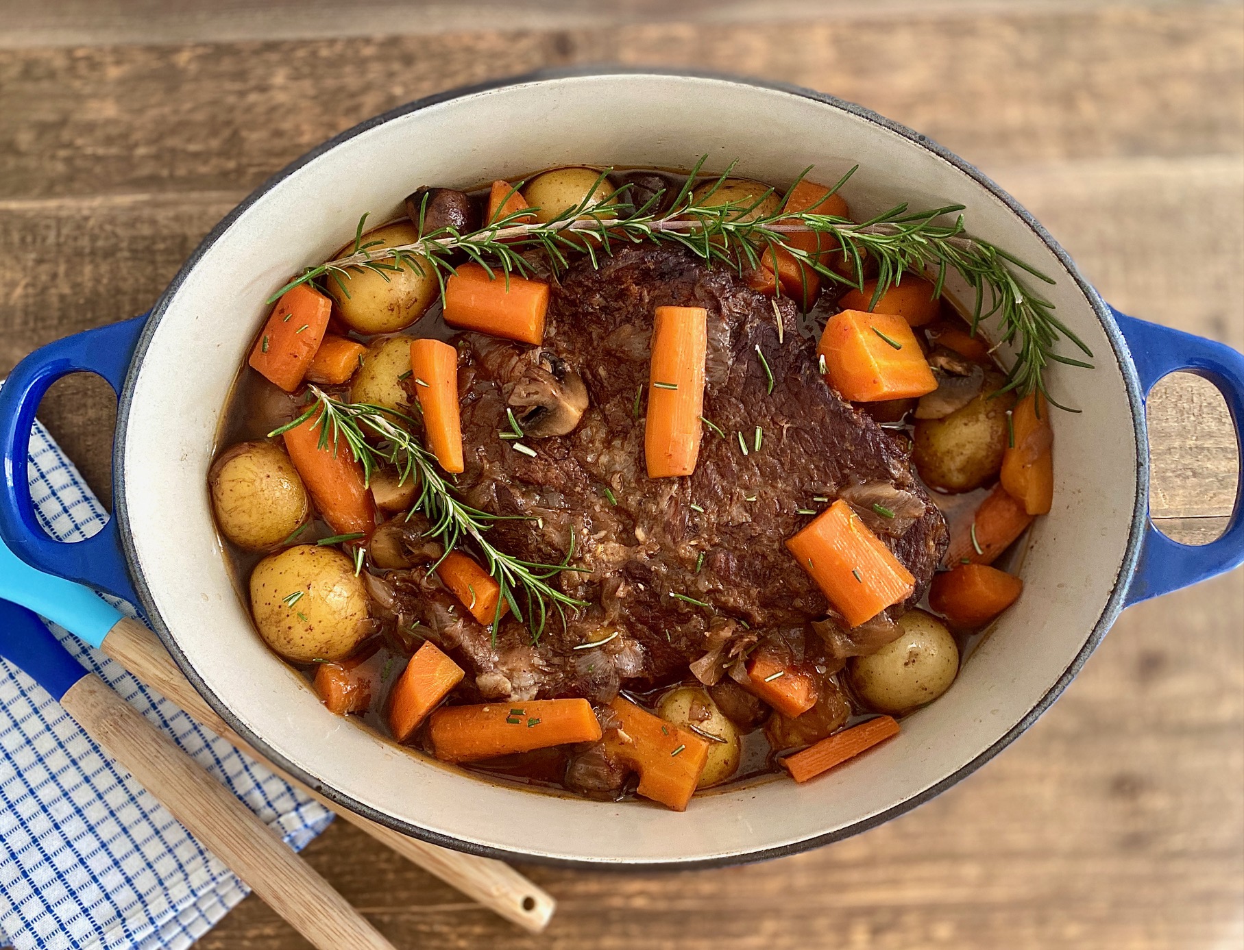 Pan of pot roast with spoons
