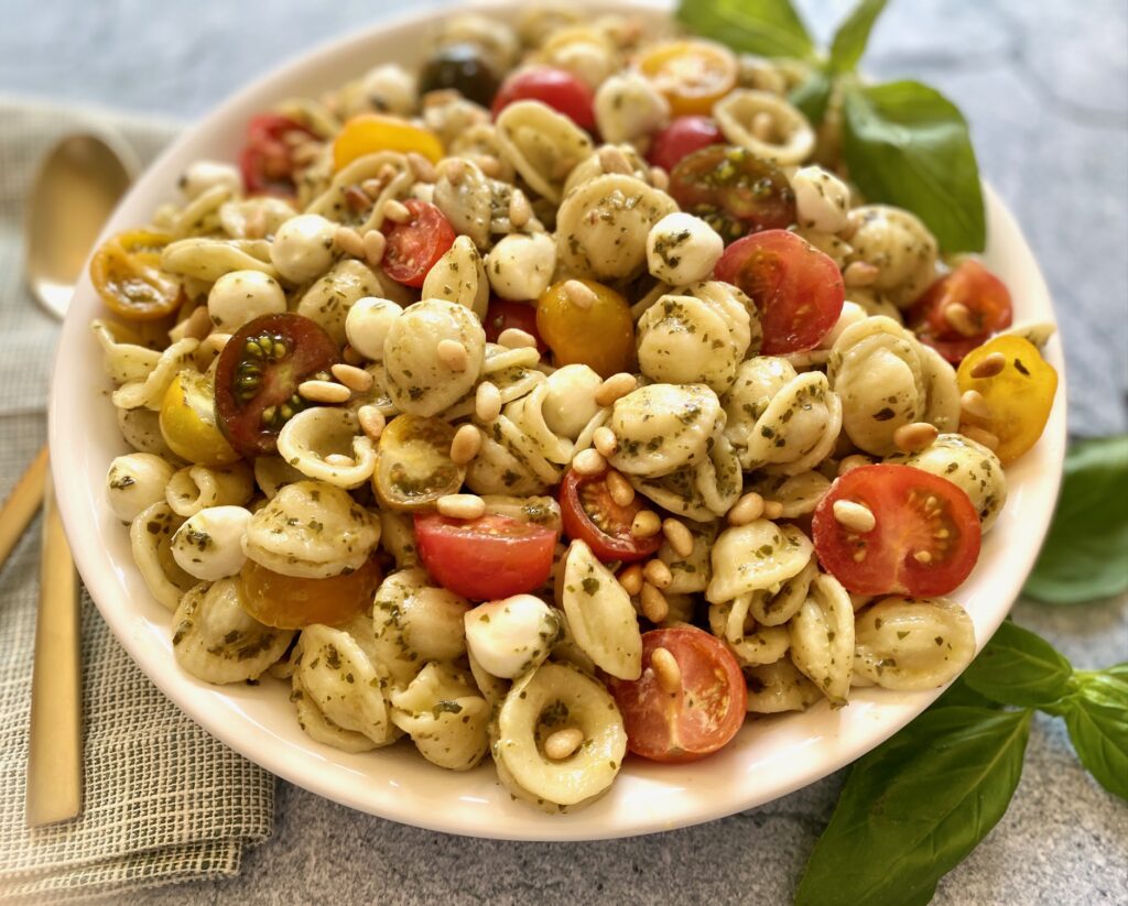 a bowl of pesto pasta salad