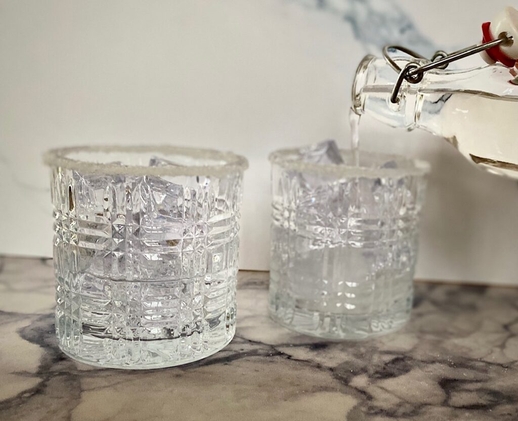 pouring liquid sugar into cocktail glasses