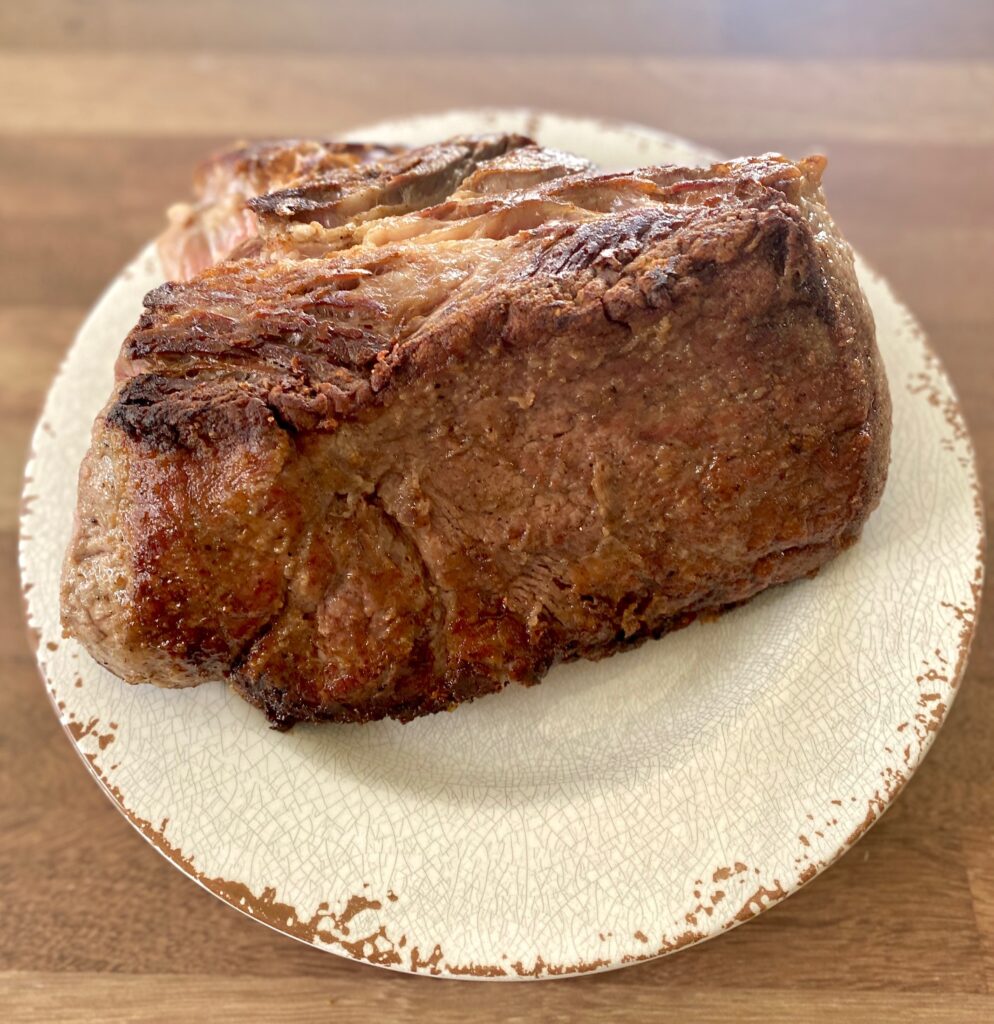 seared meat on a white plate