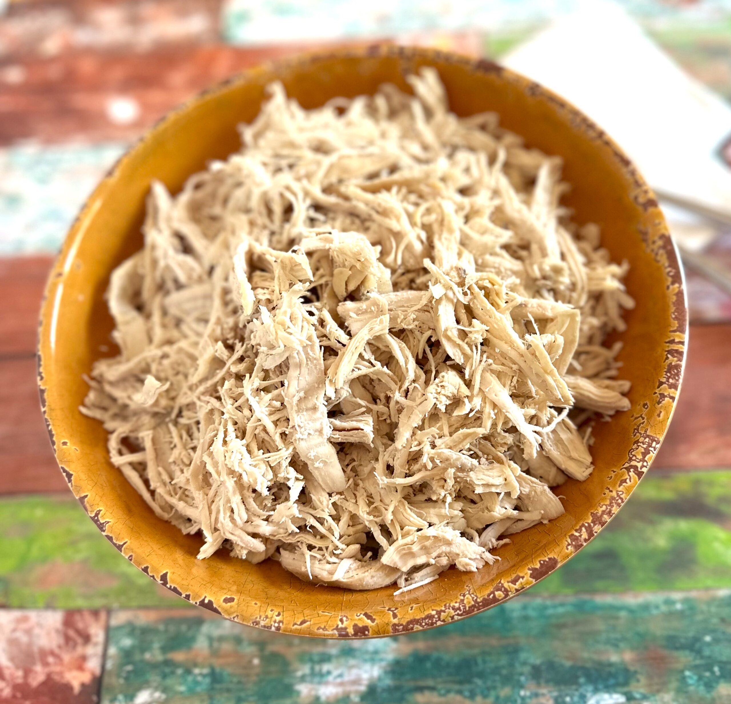 shredded chicken in a yellow bowl