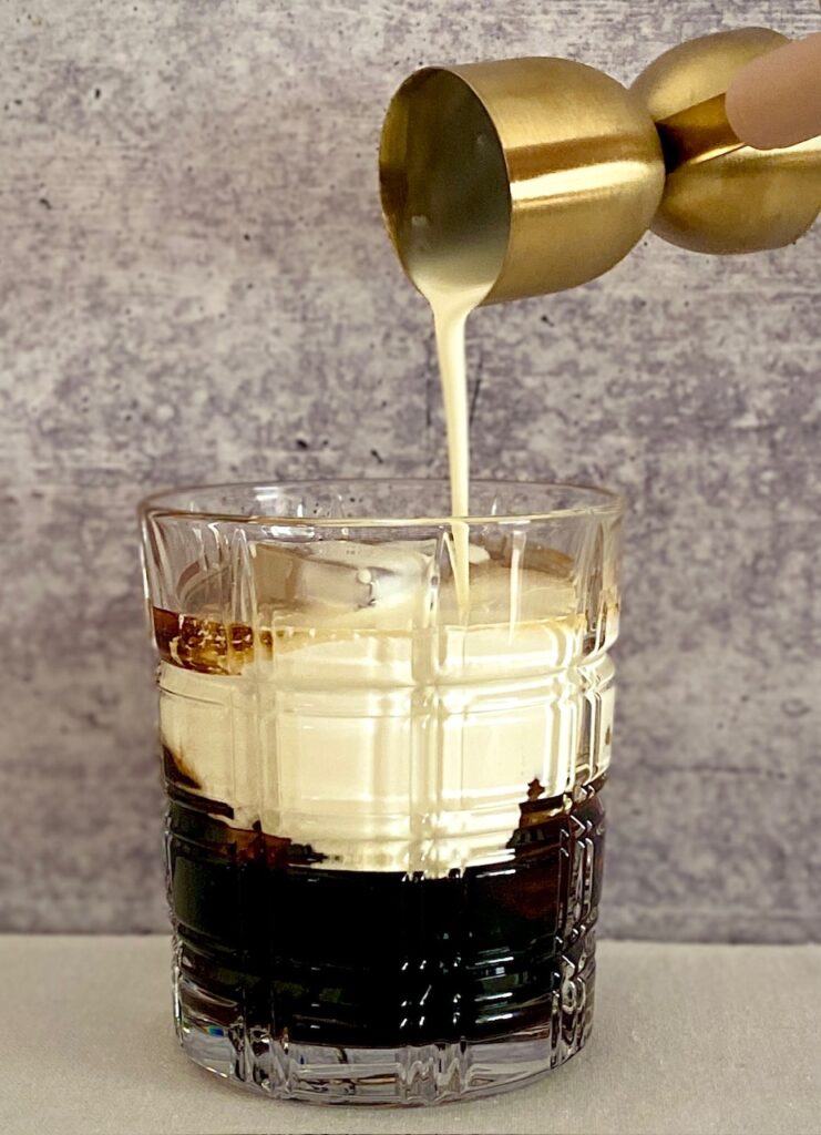 pouring cream into cocktail